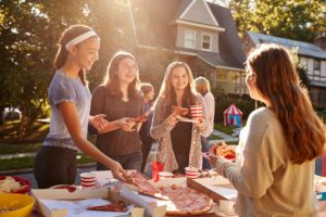 enjoying pizza at a neighborhood get together