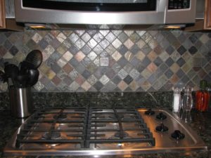 metal and slate mosaic tile backsplash