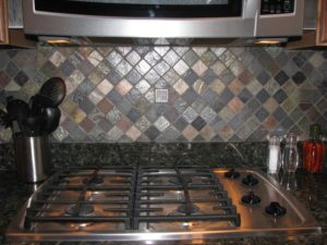 metal and slate mosaic tile backsplash