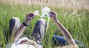 Couple holding cut-out paper houses