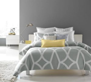 Gray bedroom with bright yellow pillow